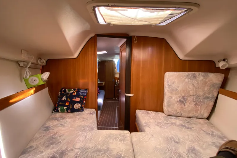 Slide: The Image of Interior of 2006 Catalina 309 sailboat with cozy cabin and wooden paneling. - 12
