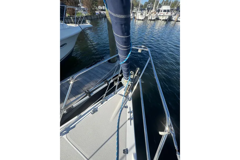 Slide: The Image of Bow of 2006 Catalina 309 sailboat docked at marina, featuring stainless steel railings. - 20