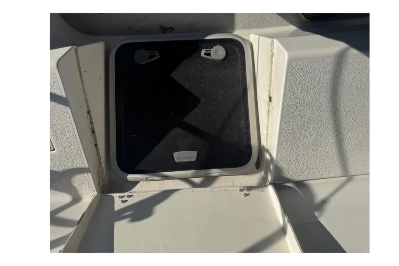 Slide: The Image of Hatch on a 2006 Catalina 309 sailboat deck, showing wear and shadows. - 23