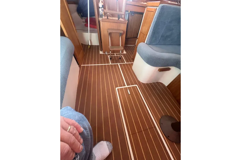 Slide: The Image of Interior of a 2006 Catalina 309 sailboat with wood flooring and seating. - 27