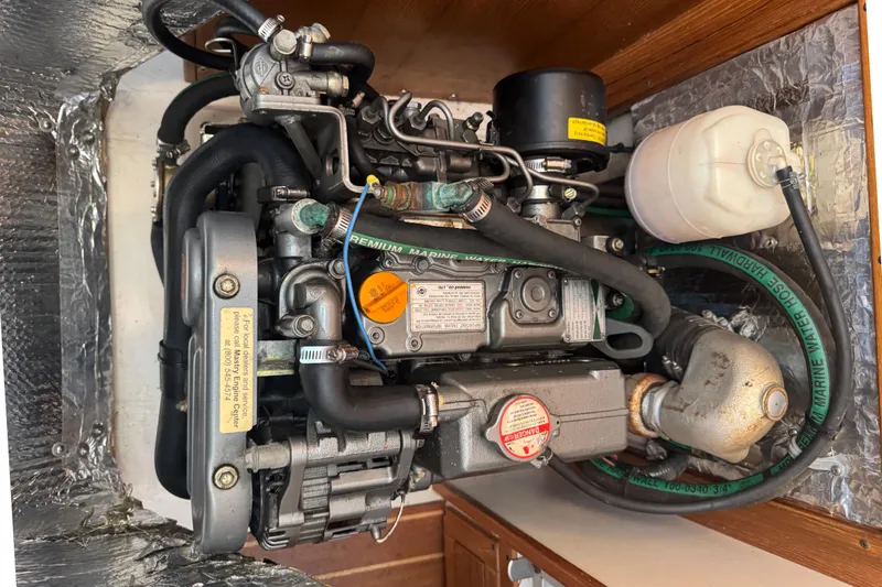Slide: The Image of Engine compartment of a 2006 Catalina 309 sailboat, showcasing detailed mechanical components. - 34