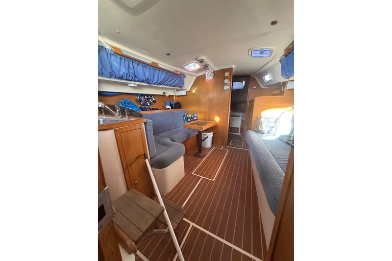 Slide: The Image of Interior of 2006 Catalina 309 sailboat with cozy seating and wooden finishes. - 35