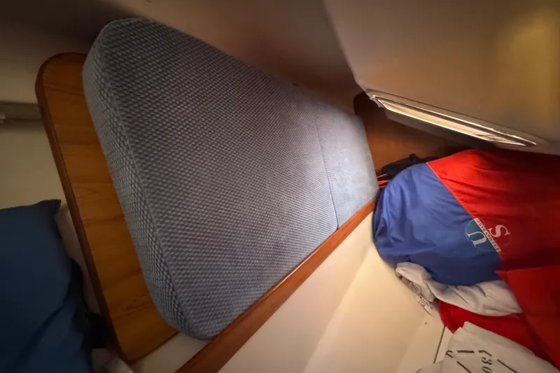 Slide: The Image of Interior of a 2006 Catalina 309 sailboat with cushions and colorful sail bags. - 36