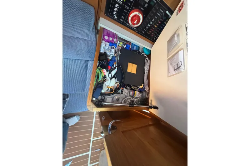 Slide: The Image of Drawer with assorted items and control panel in 2006 Catalina 309 sailboat. - 39