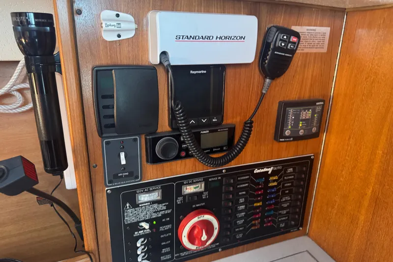 Slide: The Image of Control panel of a 2006 Catalina 309 sailboat with navigation and communication equipment. - 40