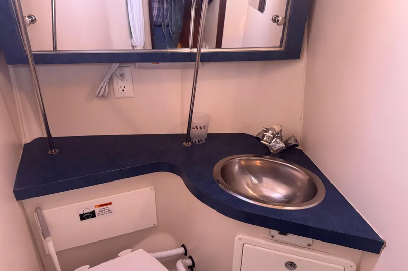 Slide: The Image of Compact bathroom in a 2006 Catalina 309 sailboat with sink and mirror. - 42
