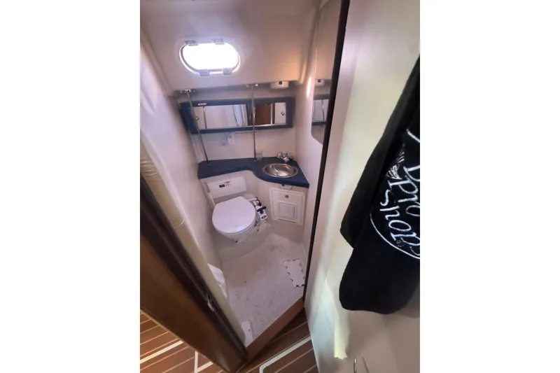 Slide: The Image of Compact bathroom in a 2006 Catalina 309 sailboat, featuring a toilet and sink. - 43