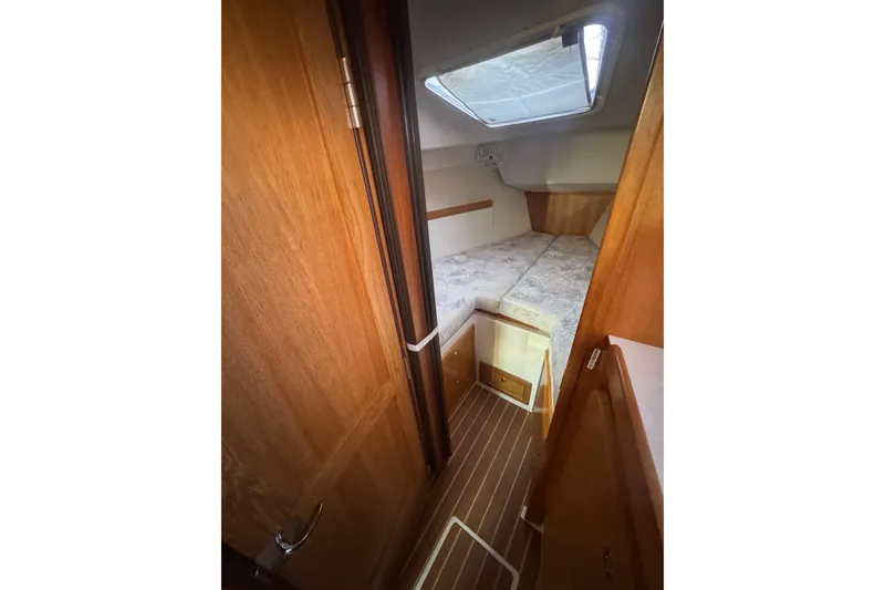 Slide: The Image of Interior cabin of 2006 Catalina 309 sailboat with wooden finish and cozy sleeping area. - 44