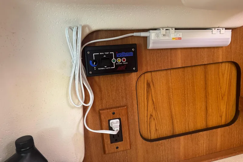 Slide: The Image of Control panel and power outlet on 2006 Catalina 309 boat interior. - 50