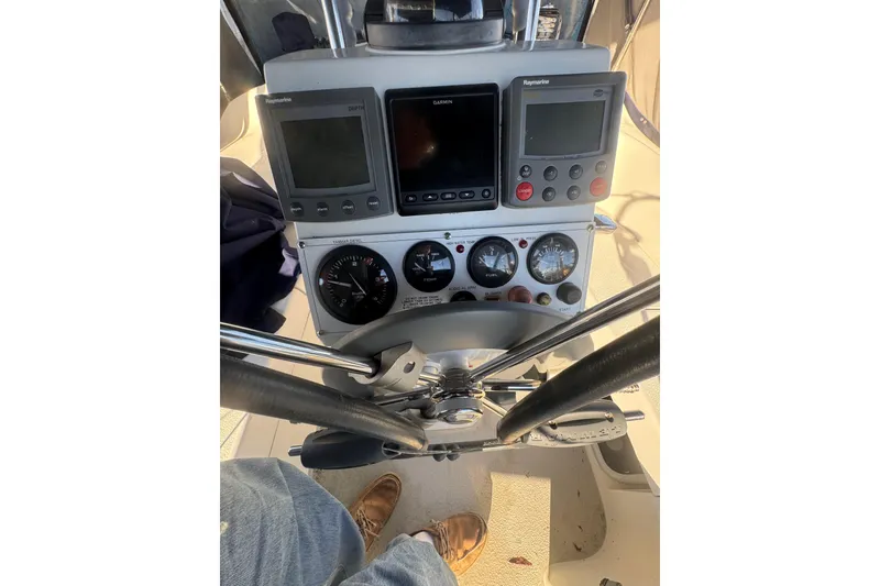 Slide: The Image of Cockpit of 2006 Catalina 309 sailboat with navigation instruments and steering wheel. - 54