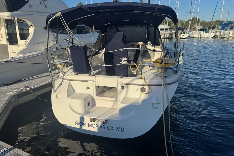 Slide: The Image of Catalina 309 sailboat, 2006 model, docked at marina with blue canopy and equipment. - 61