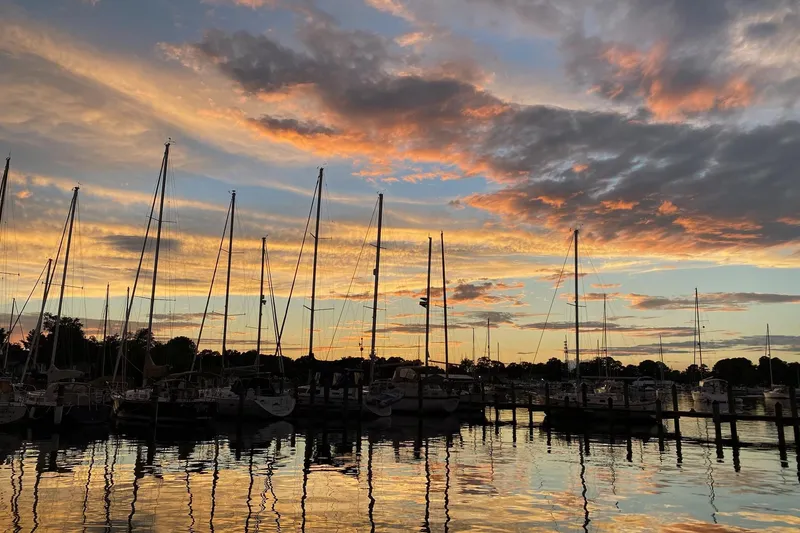 Slide: The Image of Marina sunset with Catalina 309 sailboats, 2006 model, reflecting on calm water. - 7