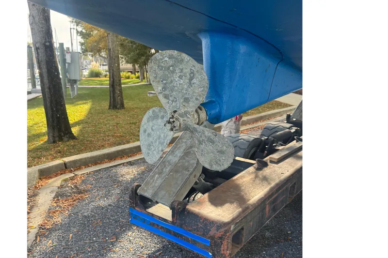 Slide: The Image of Catalina 309 sailboat propeller, 2006 model, on a trailer in a park setting. - 70