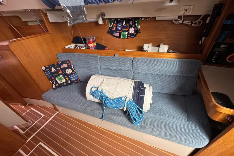 Slide: The Image of Interior of a 2006 Catalina 309 sailboat with blue seating and nautical decor. - 71