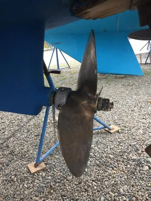 Slide: The Image of Propeller of a 2006 Catalina 309 sailboat on gravel, supported by stands. - 9