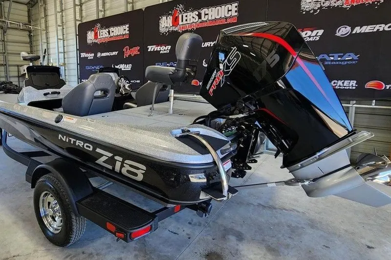 Slide: The Image of 2026 Nitro Z18 Pro fishing boat with powerful outboard motor in showroom. - 5