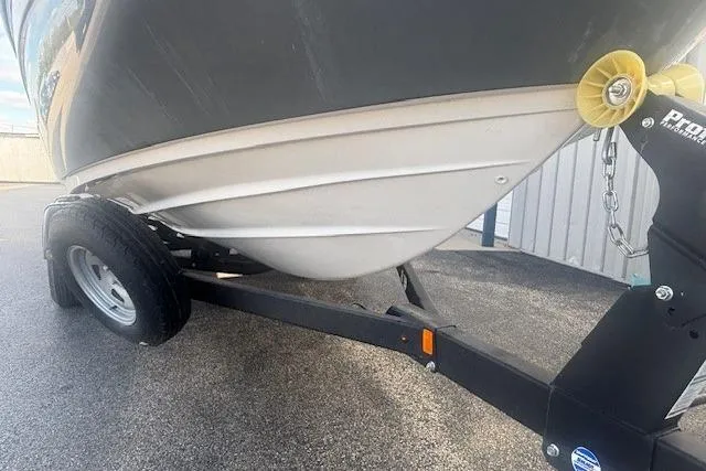 Slide: The Image of 2020 Yamaha AR210 boat on trailer, showing hull and wheel detail. - 13