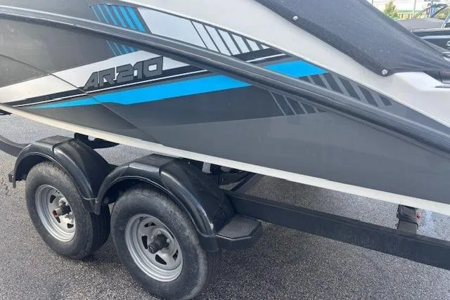 Slide: The Image of 2020 Yamaha AR210 boat on trailer, featuring sleek gray and blue design. - 15