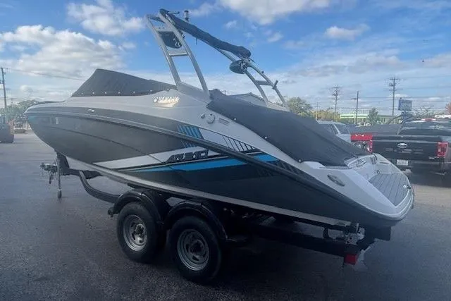 Slide: The Image of 2020 Yamaha AR210 boat on trailer, parked outdoors under a cloudy sky. - 4