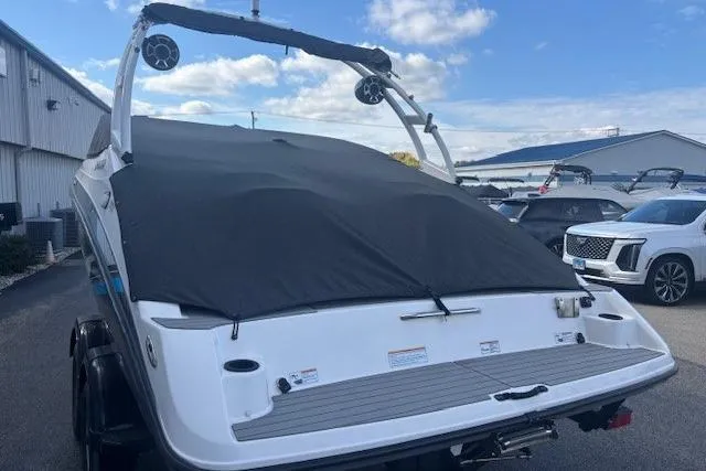 Slide: The Image of 2020 Yamaha AR210 boat with cover, parked outdoors under a blue sky. - 5