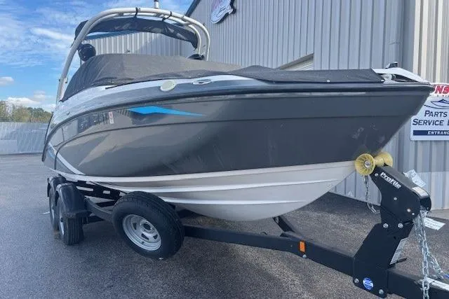 Slide: The Image of 2020 Yamaha AR210 boat on trailer, parked outdoors near a building. - 7