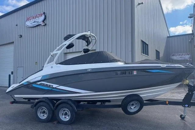 Slide: The Image of 2020 Yamaha AR210 boat on trailer outside a warehouse. - 8