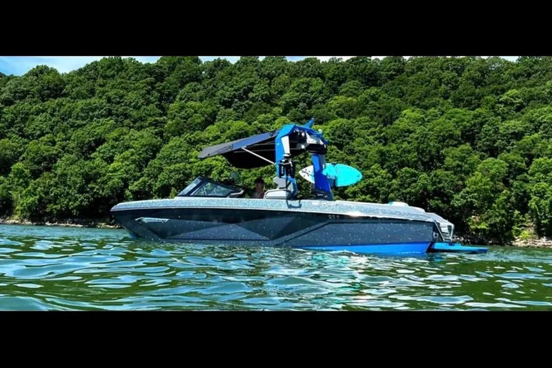The Image of 2022 Nautique Super Air Nautique G23 boat on a scenic lake with autumn foliage. - 0
