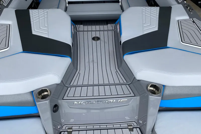 Slide: The Image of 2022 Nautique Super Air Nautique G23 boat on a lake with autumn trees. - 12