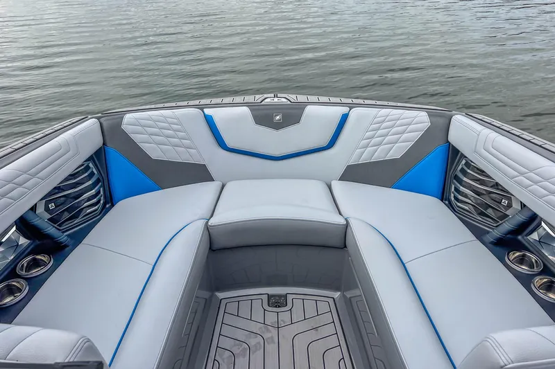 Slide: The Image of Luxurious interior of 2022 Nautique Super Air Nautique G23 boat with blue accents. - 19