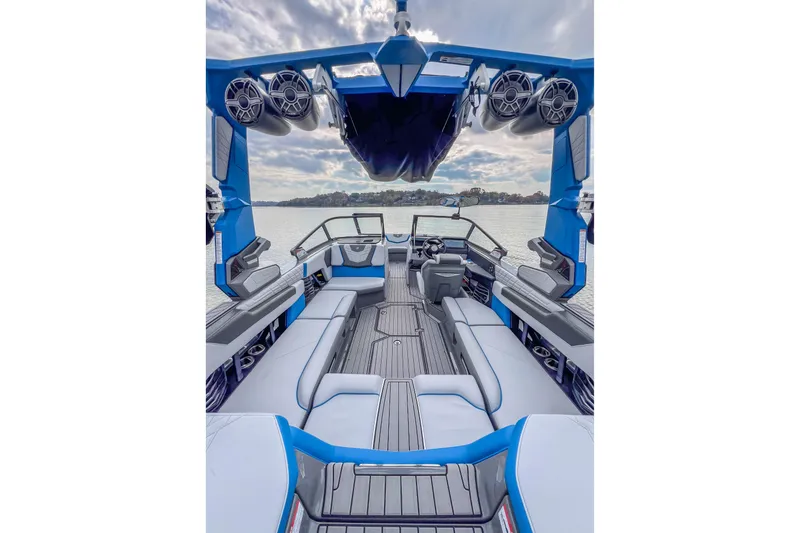 Slide: The Image of 2022 Nautique Super Air Nautique G23 interior with blue accents and lake view. - 28