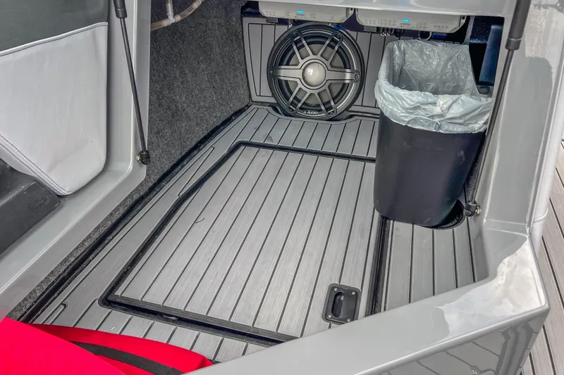 Slide: The Image of 2022 Nautique Super Air Nautique G23 interior with speaker and trash bin. - 29
