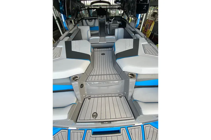 Slide: The Image of 2022 Nautique Super Air Nautique G23 boat on a lake with autumn trees in the background. - 3