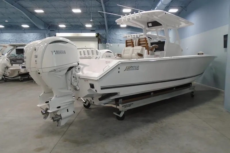 The Image of 2026 Jupiter 32 boat with Yamaha engines in a showroom setting. - 0
