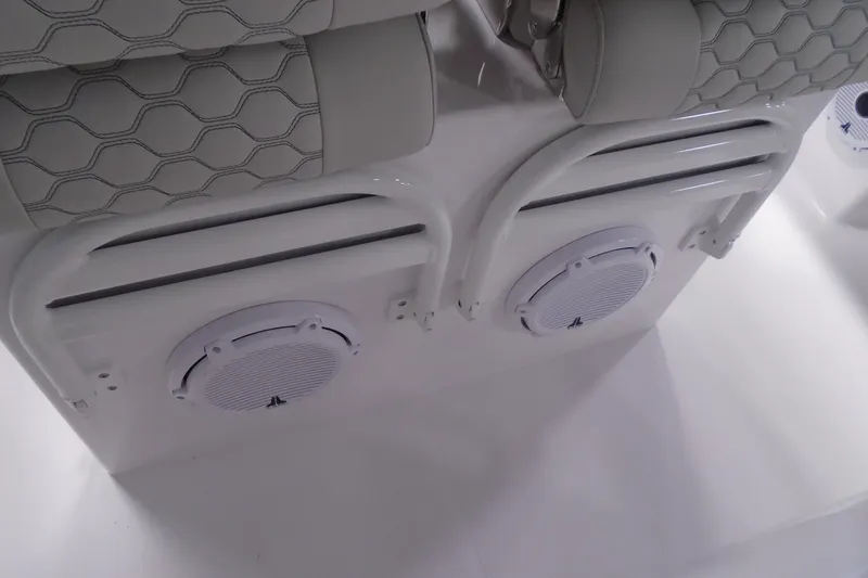 Slide: The Image of White boat interior with speakers and cushioned seating, Jupiter 32 model, 2026. - 10