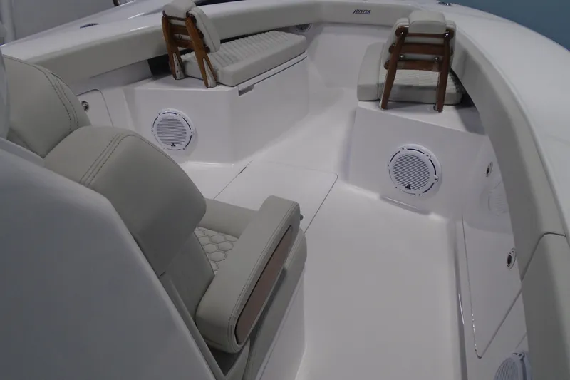 Slide: The Image of Interior of 2026 Jupiter 32 boat with cushioned seating and built-in speakers. - 14