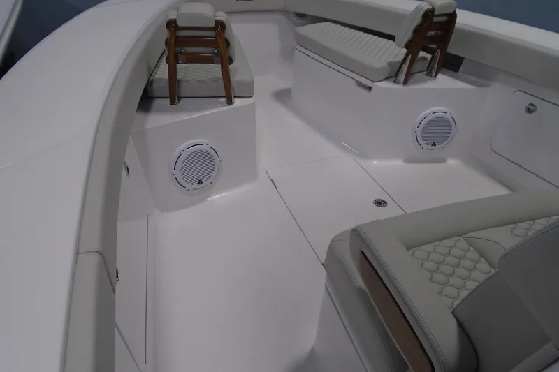 Slide: The Image of Interior of a 2026 Jupiter 32 boat with cushioned seating and built-in speakers. - 15