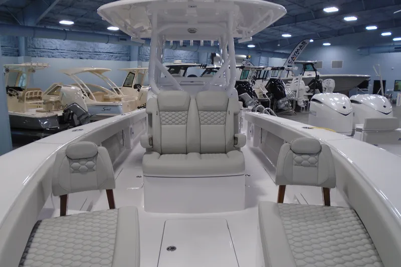 Slide: The Image of 2026 Jupiter 32 boat interior with luxurious seating in a showroom. - 18