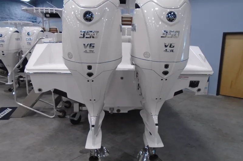 Slide: The Image of Twin 350 V6 outboard engines on a Jupiter 32 boat, 2026 model. - 2