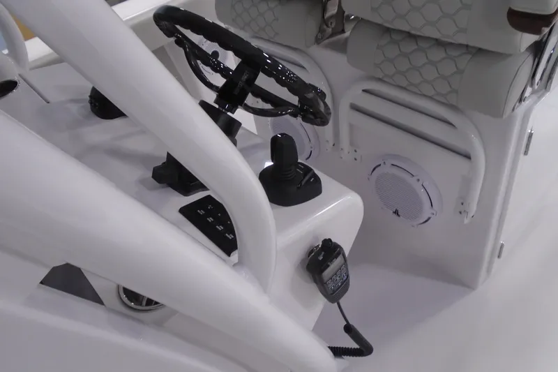 Slide: The Image of Control console of a 2026 Jupiter 32 boat with steering wheel and communication device. - 23