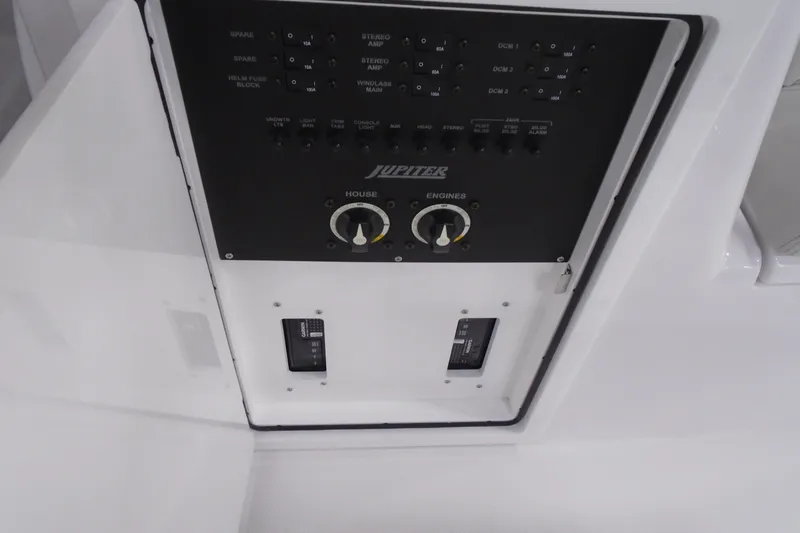 Slide: The Image of Control panel of a 2026 Jupiter 32 boat with switches and dials. - 24