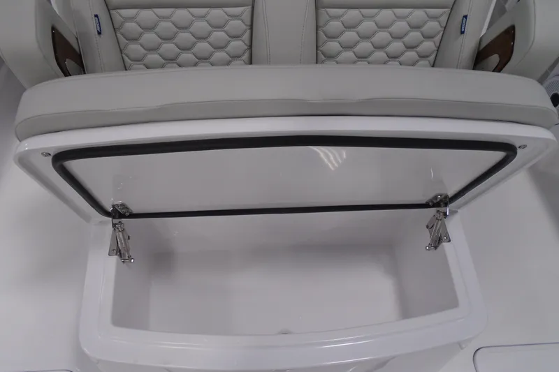 Slide: The Image of Open storage compartment on a 2026 Jupiter 32 boat with cushioned seating. - 25