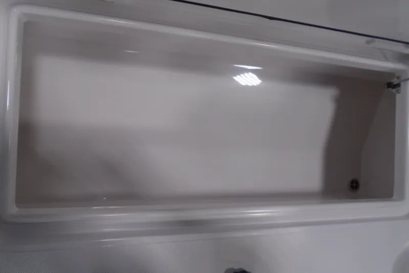 Slide: The Image of Storage compartment on a 2026 Jupiter 32 boat, featuring a sleek, white interior design. - 27