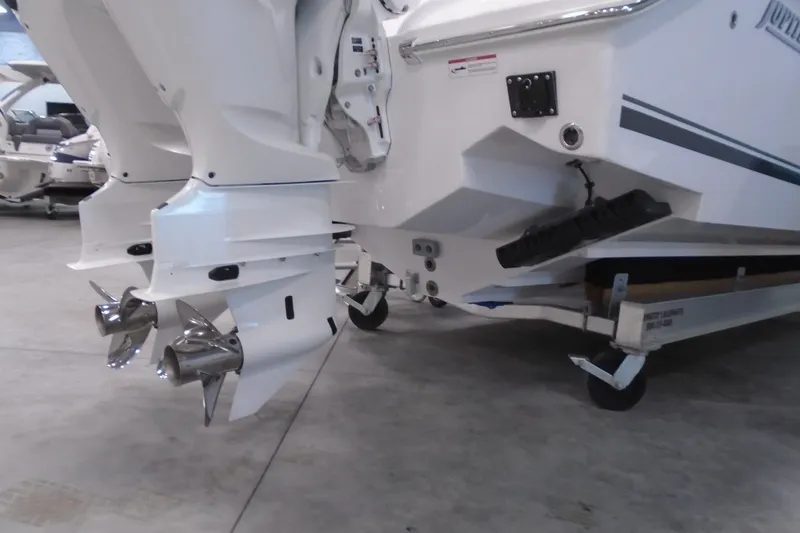 Slide: The Image of 2026 Jupiter 32 boat with dual outboard engines on a trailer in a showroom. - 3