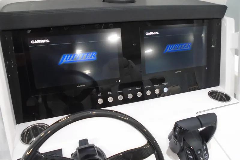 Slide: The Image of 2026 Jupiter 32 boat dashboard with dual Garmin displays and control panel. - 32
