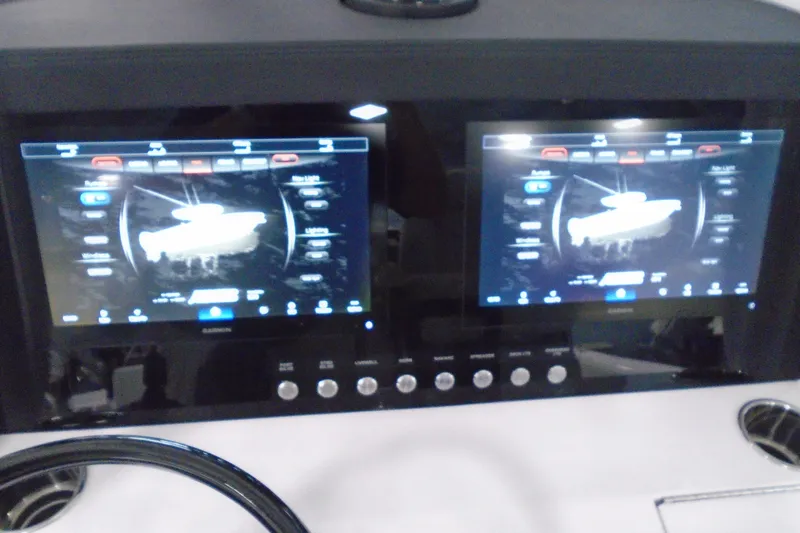Slide: The Image of Dual touchscreen displays on a 2026 Jupiter 32 boat dashboard. - 35