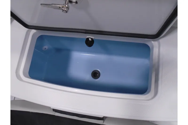 Slide: The Image of Open storage compartment in a 2026 Jupiter 32 boat, featuring a blue interior. - 36