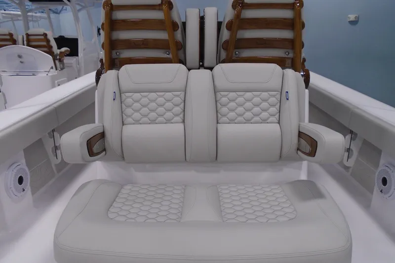 Slide: The Image of Luxurious seating on a 2026 Jupiter 32 boat, featuring elegant white upholstery and wooden accents. - 4