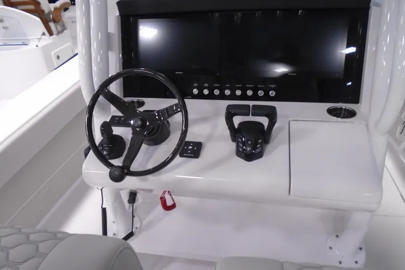 Slide: The Image of 2026 Jupiter 32 boat dashboard with steering wheel and control panel. - 6