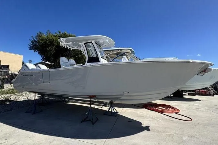 Slide: The Image of 2026 Sportsman Heritage 261 Center Console boat on display outdoors. - 1