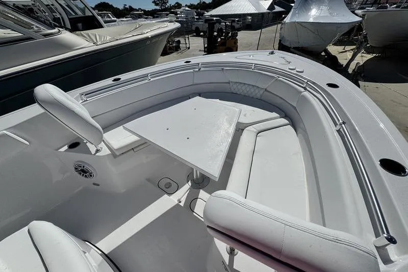 Slide: The Image of 2026 Sportsman Heritage 261 Center Console boat with spacious seating and table setup. - 10